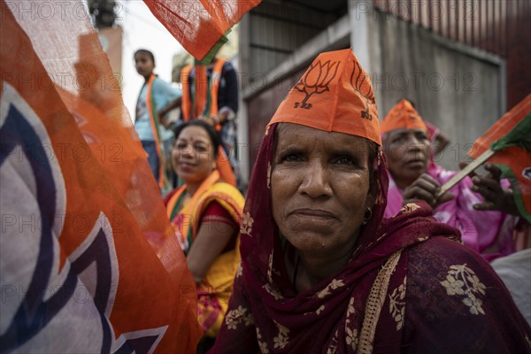 Bharatiya Janata Party (BJP) supporters arrives to to see a roadshow of Union Home minister Amit
