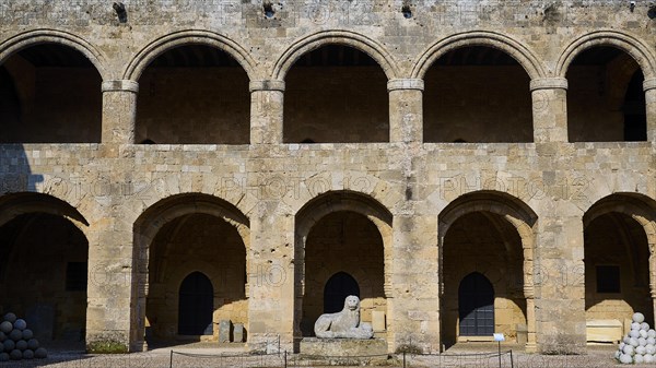 Medieval fortress with arcades and old stone walls, peaceful atmosphere, outdoor area,