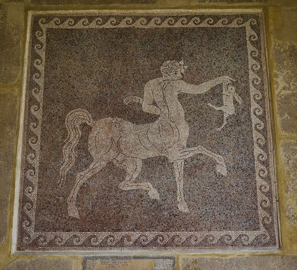 Ancient floor mosaic with a depiction of a centaur, complex stone setting and mythological scenes,