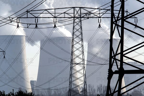Steam rises from the cooling towers of the Vattenfall power plant in Jaenschwalde, power lines and