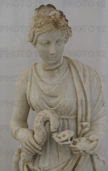 Small statue, Goddess Hygieia with snake, marble sculpture of a woman with snake, dressed in
