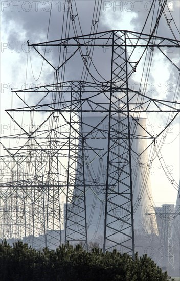 Steam rises from the cooling towers of the Vattenfall power plant in Jaenschwalde, power lines and