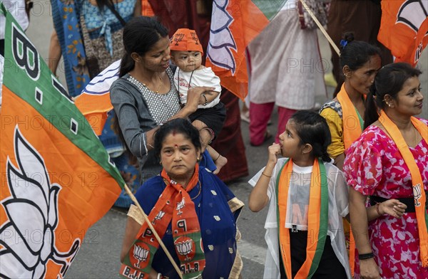 Bharatiya Janata Party (BJP) supporters arrives to to see a roadshow of Union Home minister Amit