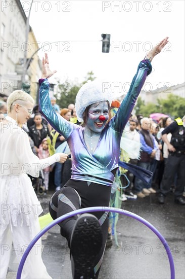 Dancer of the CABUWAZI children's and youth circus with hoops at the street parade of the 26th
