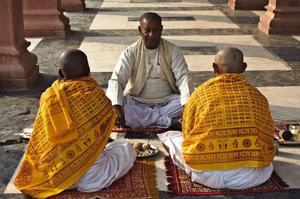 Hindu men performing a dead ancestors ritual, puja held by a brahman, Gaya, Bihar, India, Asia