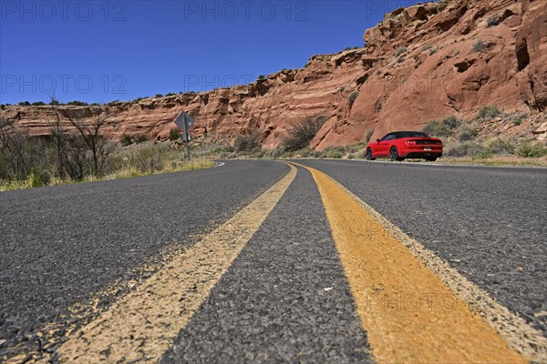 Red Ford Mustang convertible on the roadside of historic Route 66, Dead Man's Curve, New Mexico