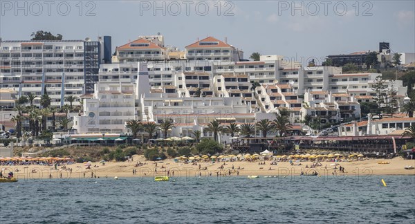 Coast with beach and hotels, people relaxing under parasols Albufeira, Algarve, Portugal, Europe