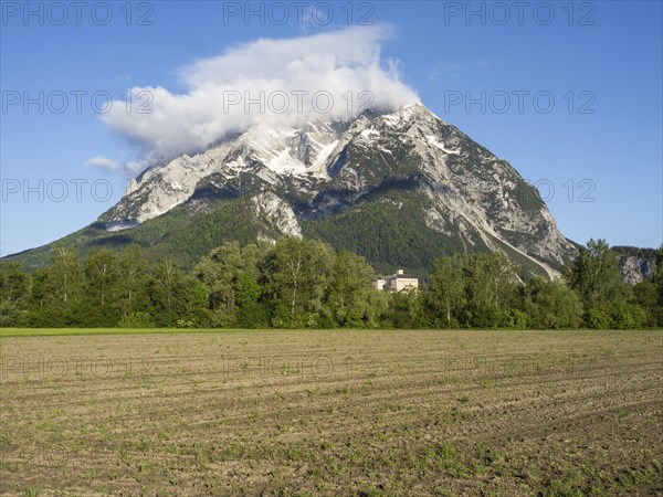 Farmland, behind the Grimming and Trautenfels Castle in the morning light, near Irdning, Styria,