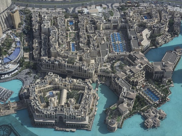 Luxury hotel complexes with several swimming pools and turquoise-coloured water, presented in