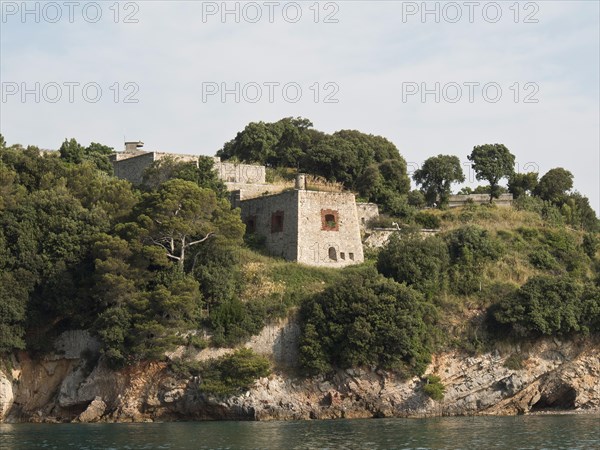 Ruins of a historic building on a wooded cliff overlooking the sea, Bari, Italy, Europe