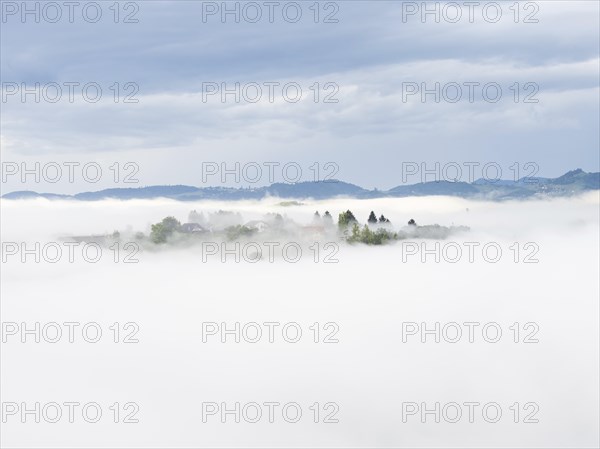 Morning fog over the village of Frauenberg, view from Silberberg, near Leibnitz, Styria, Austria,