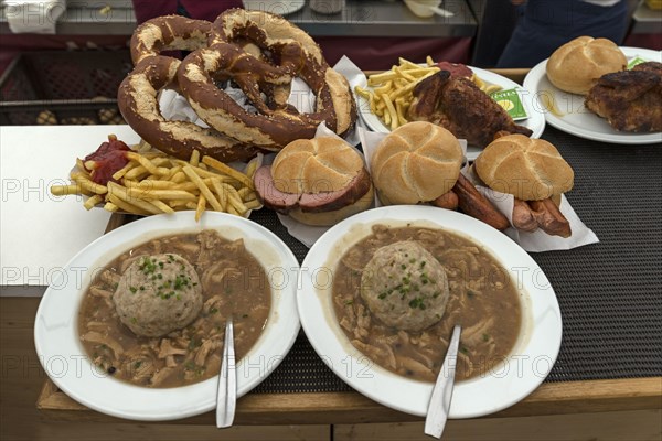 Tray with ordered marquee food, pretzels, baked Haendel, soup with liver dumplings,