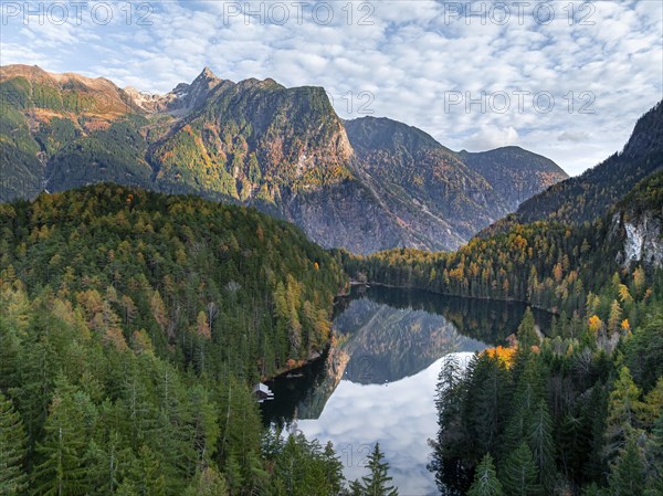 Aerial view, mountain peaks of the Oetztal Alps reflected in Lake Piburger See, in autumn, near
