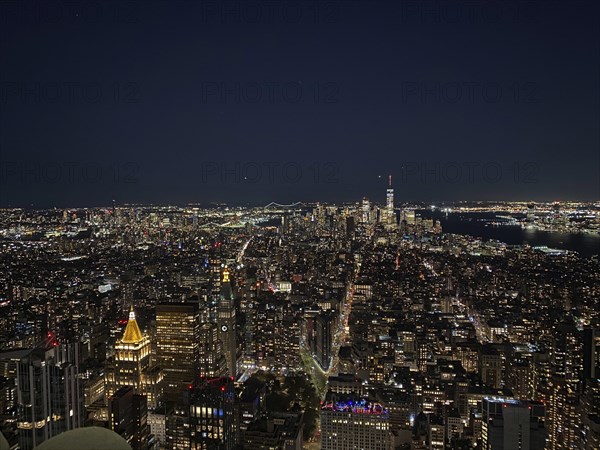 Night view of an illuminated skyline of a big city with countless skyscrapers under a clear sky,