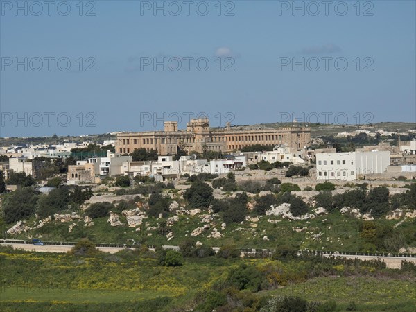 Town view with historic buildings on a hill, lots of greenery, traditional ambience, the town of
