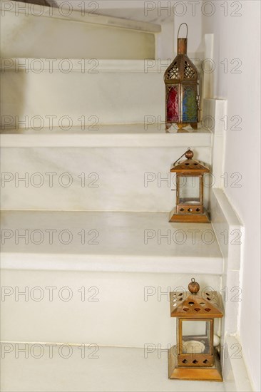 Various lanterns placed on the steps of a marble staircase