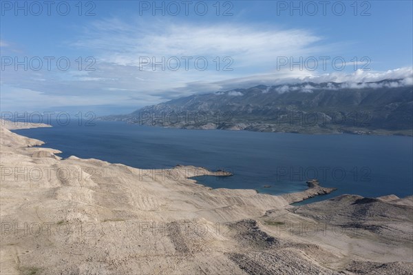 Lunar landscape, coast of the island of Pag, view of the mainland and the Velebit mountains, Zadar,