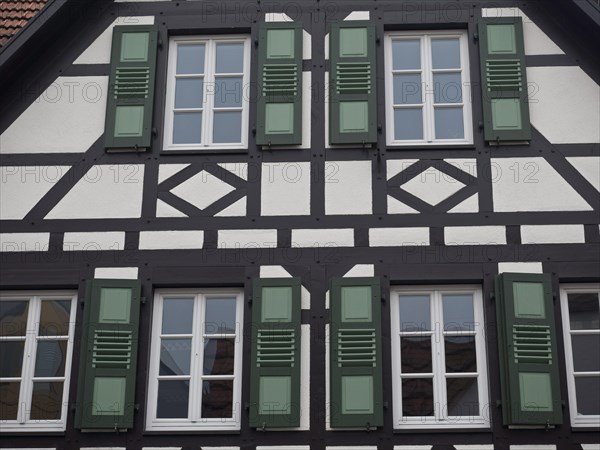 Half-timbered house with several green shutters, kandel, germany