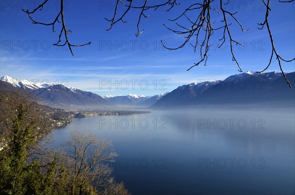 Panoramic View over Lake Maggiore with Snowcapped Mountain in a Misty Morning and in a Sunny Day in