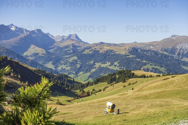 A picturesque mountain landscape with green hills and a blue sky in the sunshine, mountain panorama