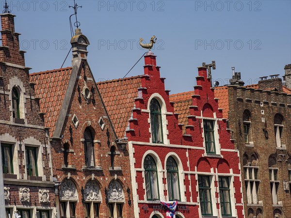 Colourful historic buildings with ornate facades and gables under a blue sky, historic house