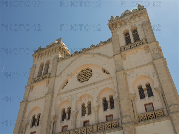 Front view of a large historic building with domes and beautiful decorations, Tunis in Africa with
