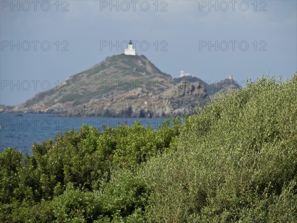 Lighthouse on a hilly, rocky cape overlooking the sea, Corsica, ajaccio, France, Europe