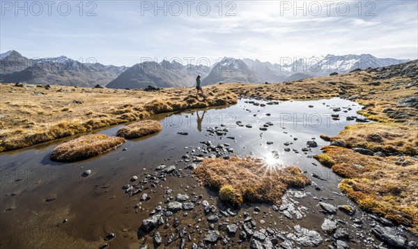 Mountaineers at a small lake on the high plateau of the Gurgler Seenplatte, glaciated mountain