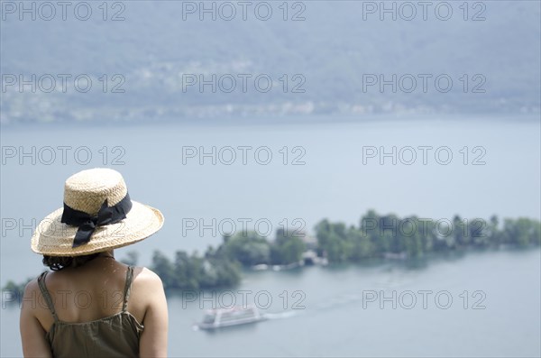 Woman with a Straw Hat Enjoy the Panoramic View over Brissago Islands and Passenger Ship on Lake