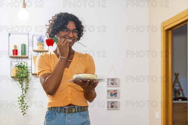Gay man with cake and rose on the mouth trying to surprise his couple at home