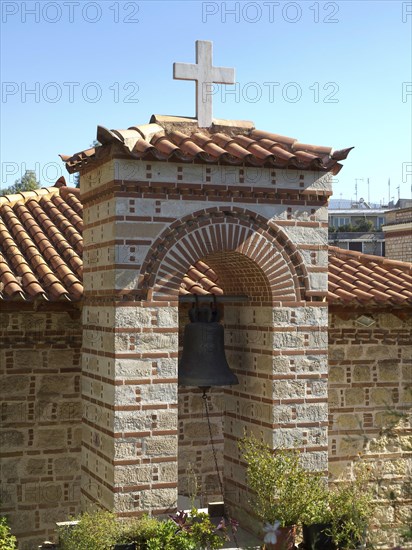 Small church with a bell and cross above surrounded by plants under a clear sky, Ancient buildings