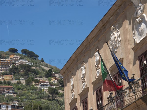 Italian and European flag building decorated and set in a hilly landscape on a sunny day, palermo