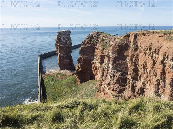 Expansive cliff landscape by the sea with clear sky, Heligoland, Germany, Europe