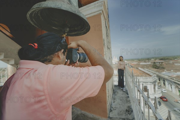 Tourists taking photographs at the viewpoint of the La Merced church, Granada. Tourist couple
