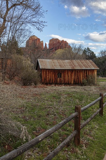 Cathedral Rock sandstone formations tower over a rustic barn at the Crescent Moon Picnic Site in