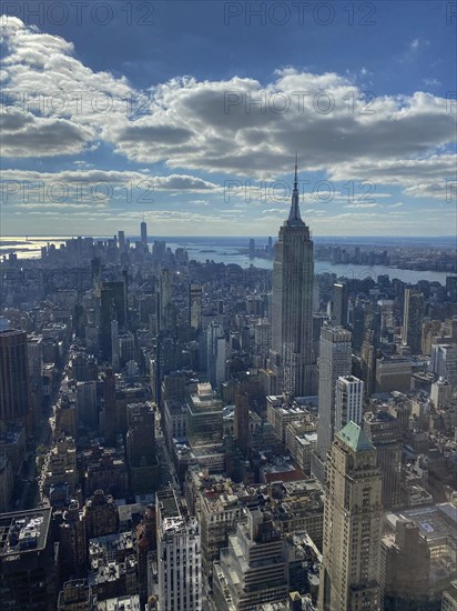 Daytime view of a big city with the Empire State Building in the foreground and many skyscrapers