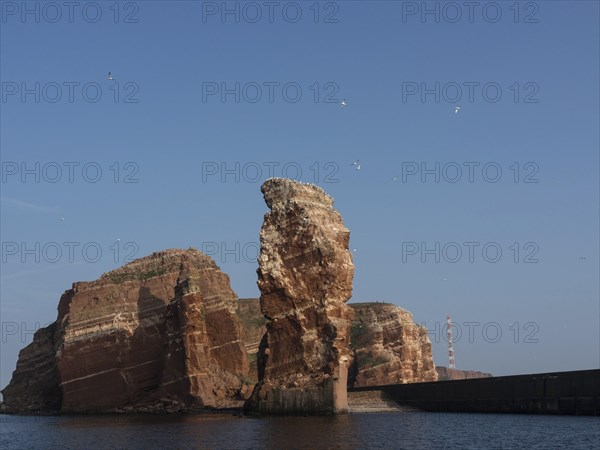 Dramatic cliff formations rise out of the sea into the sky, Heligoland, Germany, Europe