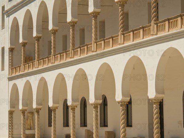 Historic building with sandstone arches and colonnades, Tunis in Africa with ruins from Roman