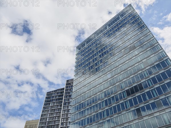 Modern skyscrapers with glass facades in Luxembourg under a slightly cloudy sky, modern buildings