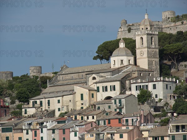 Hilly landscape with a church and bell tower surrounded by houses and castle ruins, Bari, Italy,