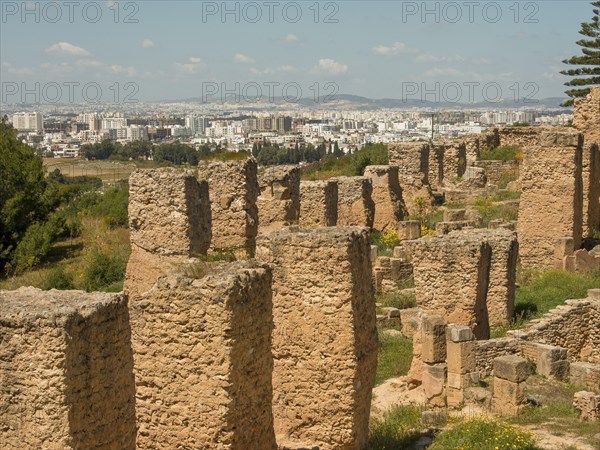 Overview of ancient ruins set against a modern urban landscape, Tunis in Africa with ruins from