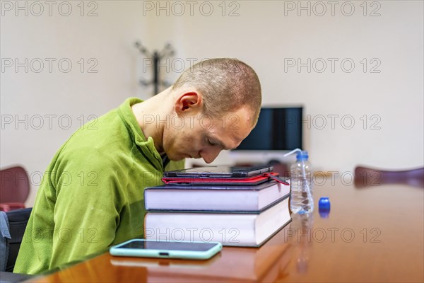 Man with cerebral palsy studying in a quiet room in the university