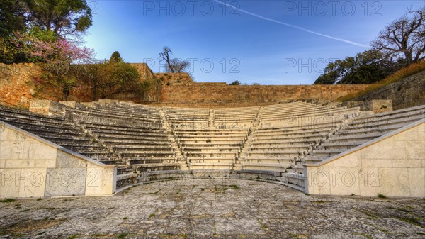 Ancient amphitheatre with stone seating steps, illuminated by soft morning sunlight, Archaeological