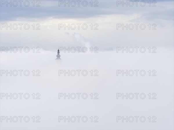 Church tower rises out of the morning mist, Frauenberg pilgrimage church, near Leibnitz, Styria,