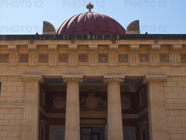 An impressive facade with columns and a dome in the background, palermo in sicily with an