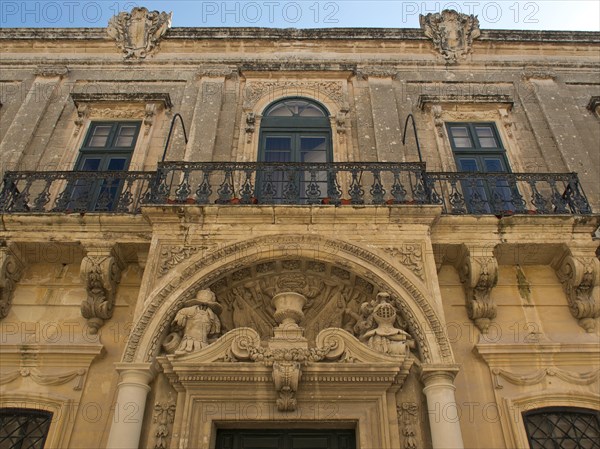 Historic building with ornate balcony and magnificent stucco ornaments, the town of mdina on the