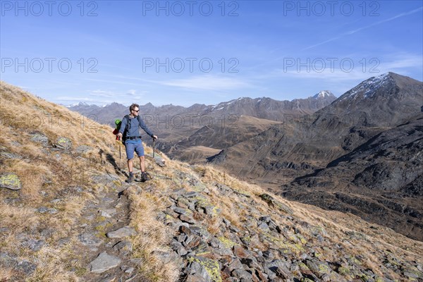 Mountaineer on a hiking trail, Gurgler Seenplatte, behind mountain peak of the Gurgler ridge, in