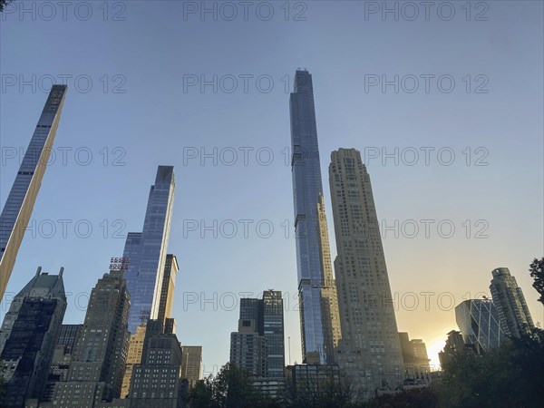 Cityscape at sunset with modern skyscrapers and the central park in the foreground, the skyline of
