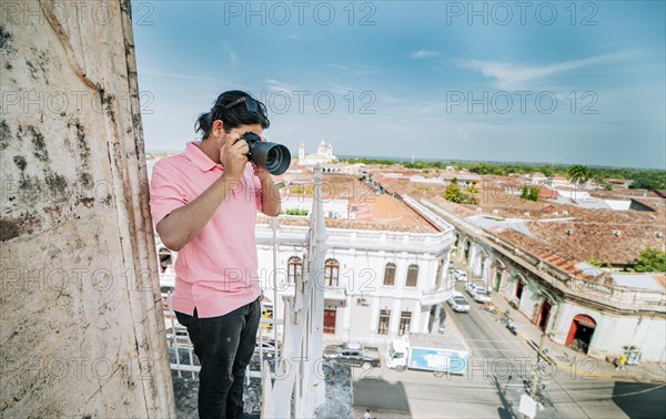 Tourist photographing the streets of Granada from the La Merced viewpoint. Tourist man taking