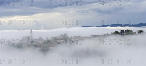 Fog clears over the village of Frauenberg, view from the Silberberg, near Leibnitz, Styria,